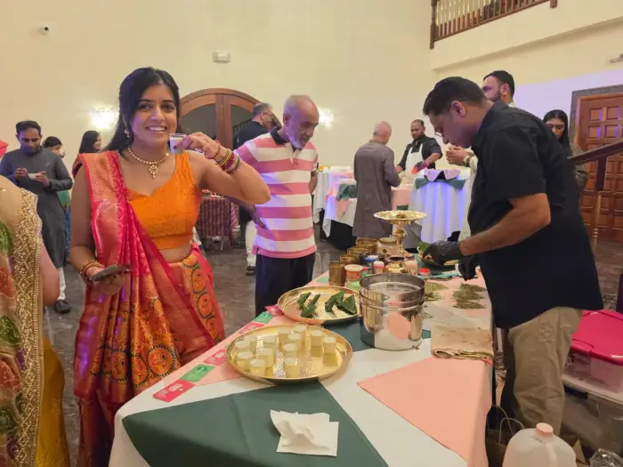Guests enjoying paan shots beside a live Paan Station counter